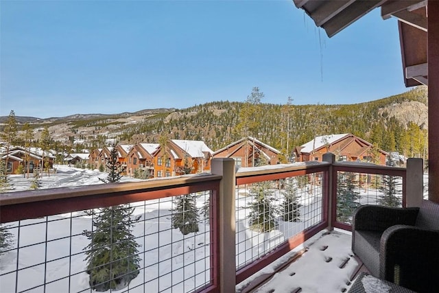 view of snow covered back of property