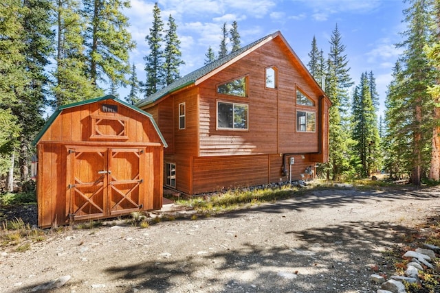 view of home's exterior with a shed