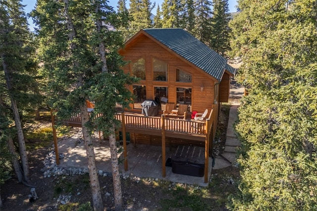 back of house with a patio and a wooden deck