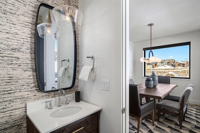 bathroom featuring vanity and a chandelier