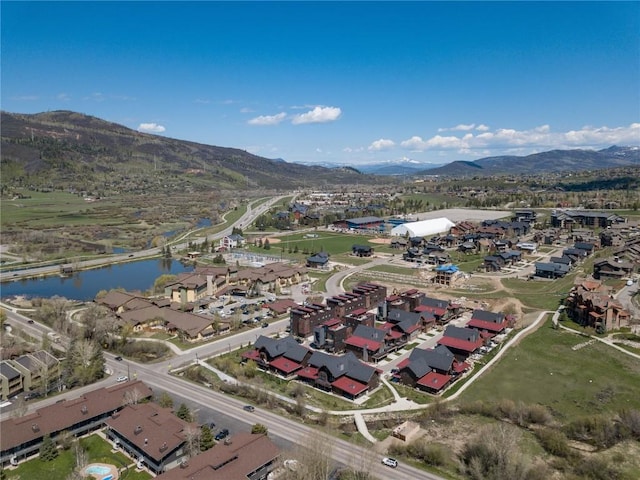 aerial view featuring a water and mountain view