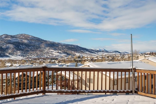 snow covered deck featuring a mountain view