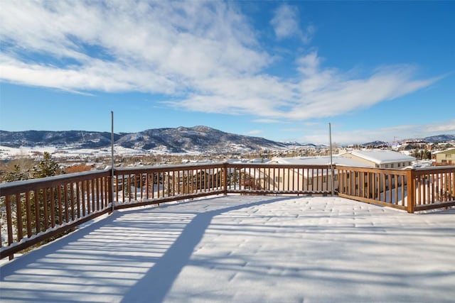 snow covered deck featuring a mountain view