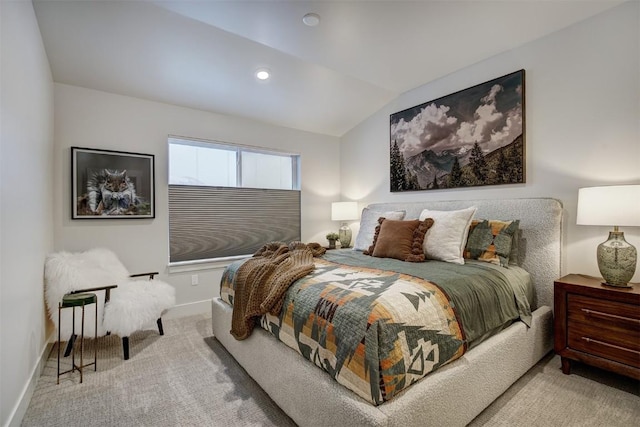 carpeted bedroom with lofted ceiling