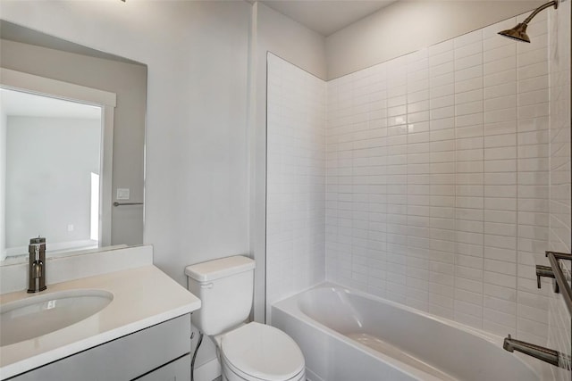 full bathroom featuring vanity, tiled shower / bath combo, and toilet