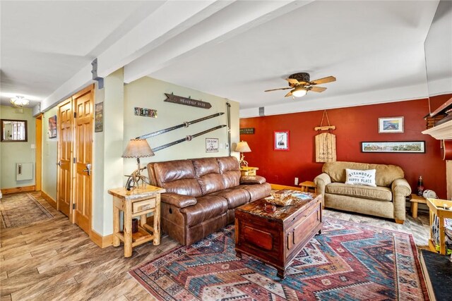 living room with a ceiling fan, wood finished floors, and baseboards