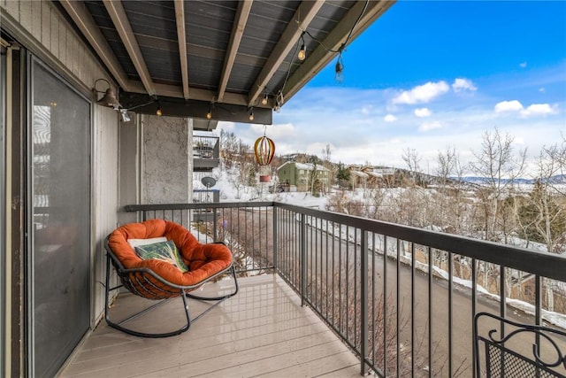 view of snow covered back of property