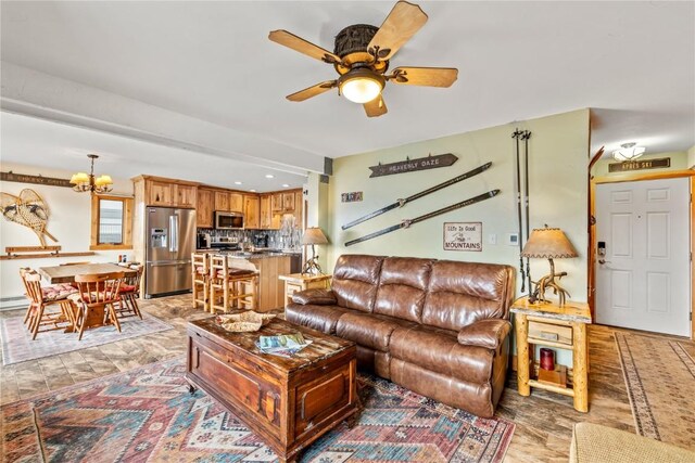 living room featuring ceiling fan with notable chandelier and a baseboard heating unit