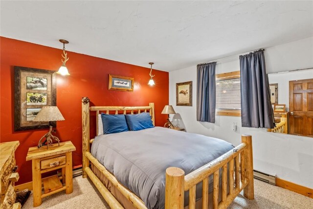 carpeted bedroom featuring baseboards and a baseboard radiator