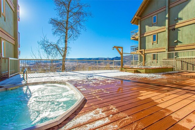 exterior space with hot tub deck surround and a deck