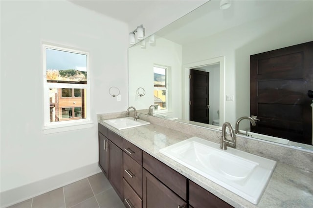 bathroom with tile patterned floors, vanity, and toilet