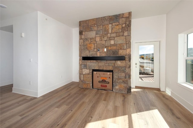 unfurnished living room with a fireplace and light hardwood / wood-style flooring