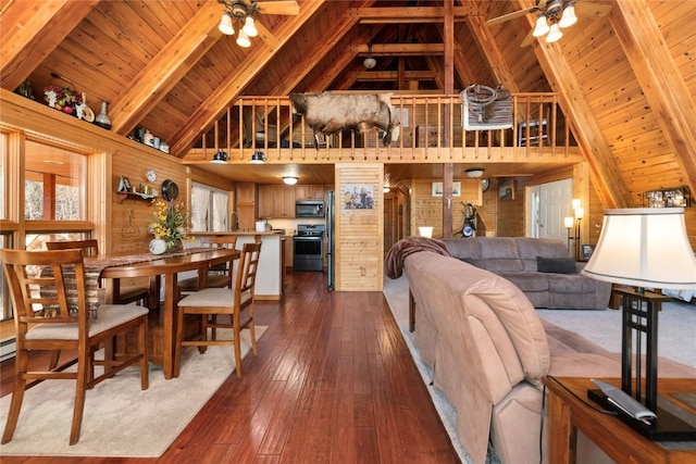 living room with high vaulted ceiling, wooden walls, ceiling fan, beam ceiling, and wood ceiling