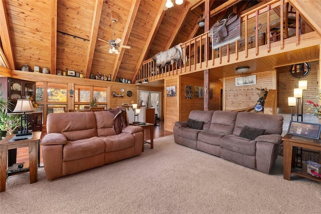 living room with ceiling fan, beamed ceiling, high vaulted ceiling, wooden walls, and wood ceiling