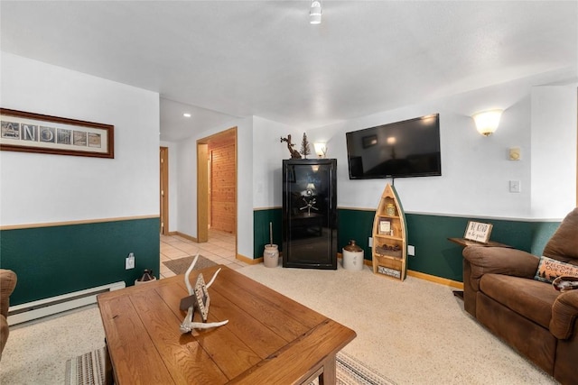 living room with a baseboard heating unit and light tile patterned flooring