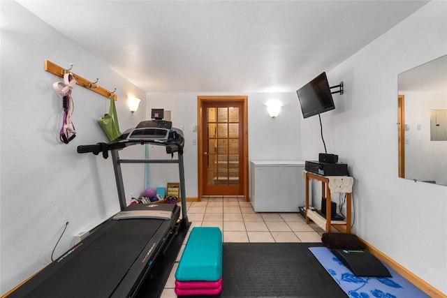 exercise area featuring light tile patterned floors and electric panel