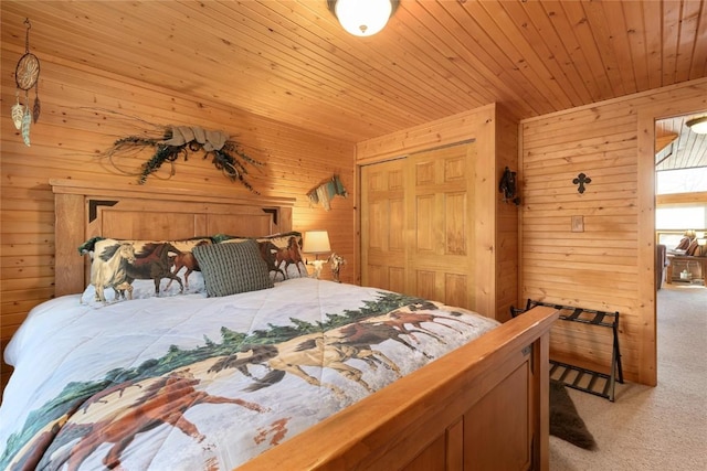 bedroom featuring wood ceiling, wooden walls, a closet, and light colored carpet