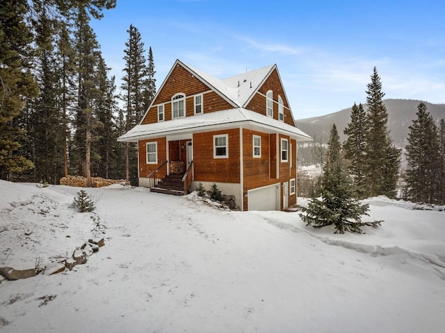 view of front facade featuring a mountain view and a garage