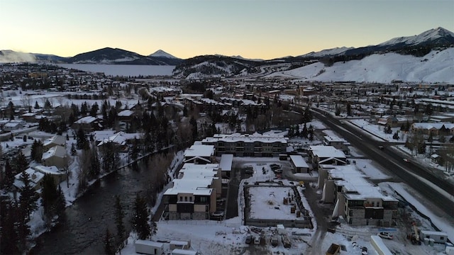 snowy aerial view with a mountain view