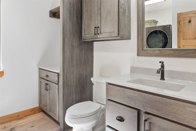 bathroom with vanity, toilet, and wood-type flooring