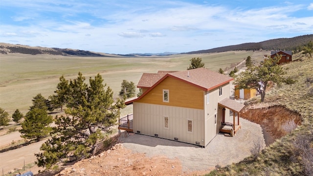 birds eye view of property with a mountain view and a rural view