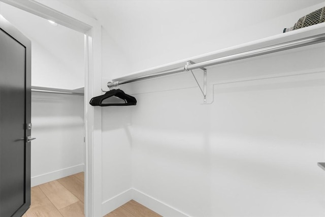 spacious closet featuring light hardwood / wood-style floors