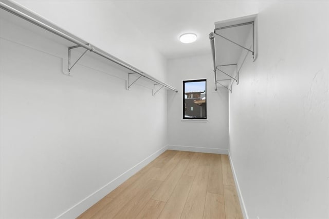 spacious closet with light hardwood / wood-style floors