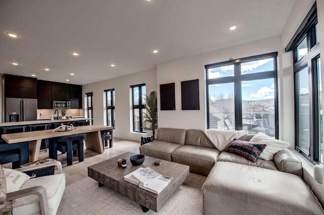 living room featuring sink and light wood-type flooring