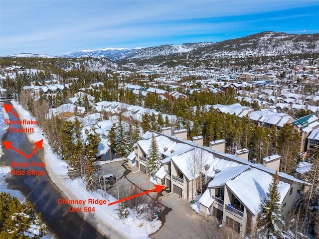 snowy aerial view featuring a mountain view