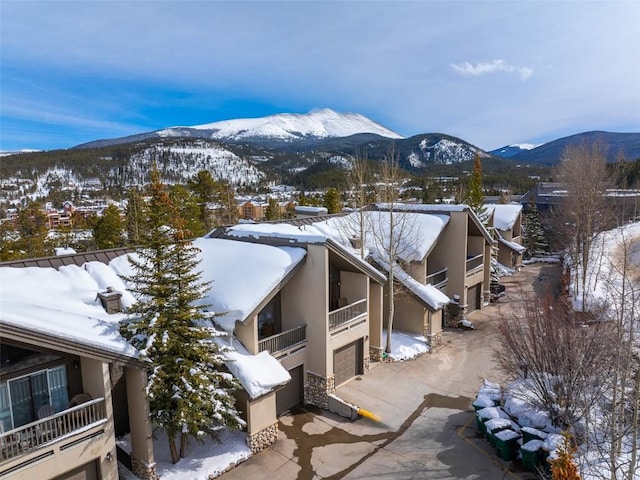 snowy aerial view featuring a mountain view