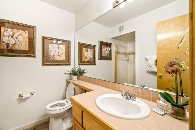 bathroom with baseboards, visible vents, toilet, an enclosed shower, and vanity