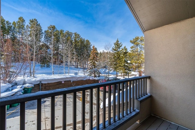 view of snow covered back of property