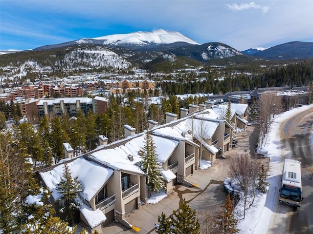 snowy aerial view with a mountain view