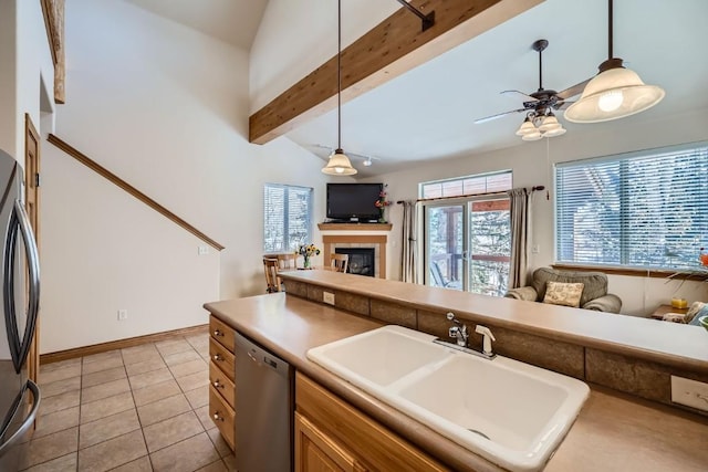 kitchen with a sink, fridge, dishwasher, and open floor plan