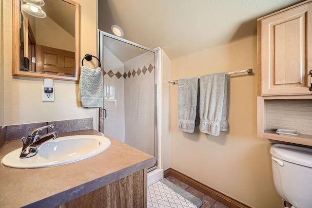 full bath featuring a sink, baseboards, toilet, and a shower stall