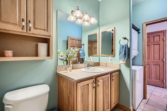 bathroom featuring toilet, stacked washer and clothes dryer, vanity, and tile patterned flooring