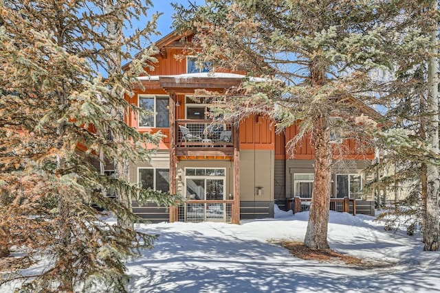 view of front of property with a balcony and board and batten siding