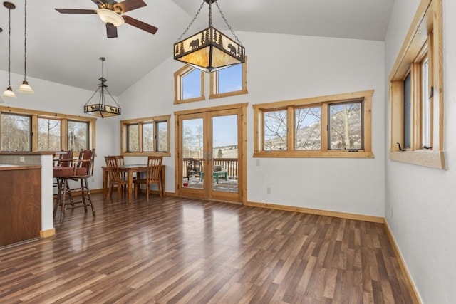 interior space with dark wood-type flooring, high vaulted ceiling, french doors, and ceiling fan