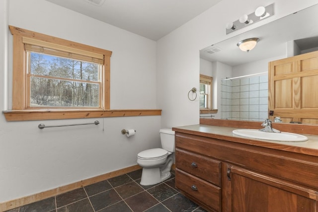 bathroom with vanity, toilet, tile patterned flooring, and a shower