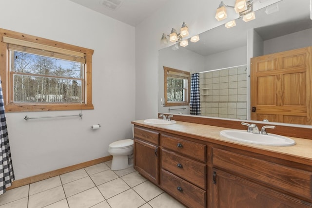 bathroom featuring walk in shower, tile patterned floors, toilet, and vanity