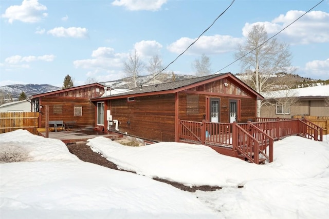 snow covered property featuring fence and french doors