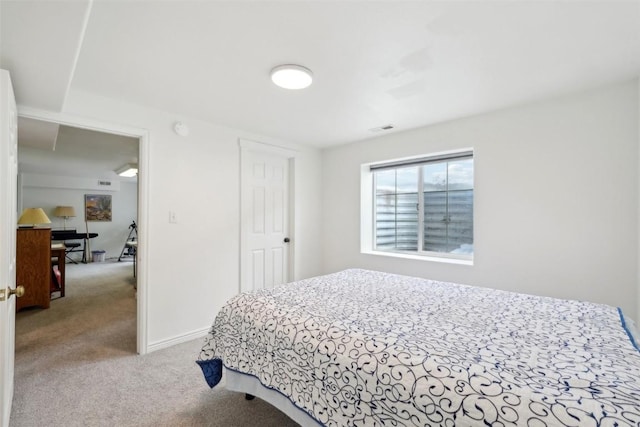 carpeted bedroom featuring visible vents and baseboards