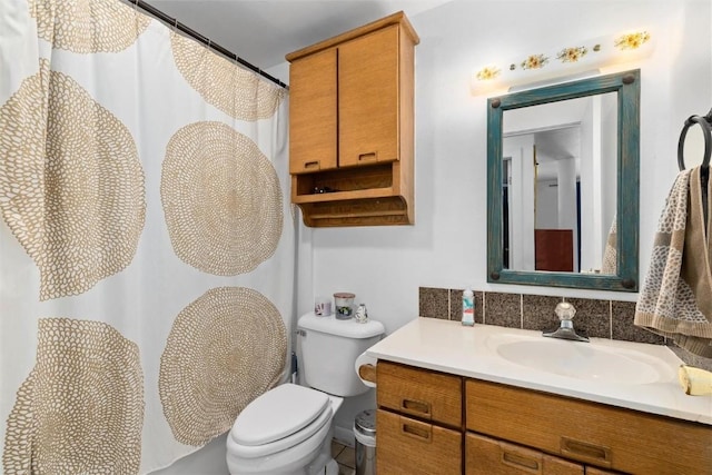 bathroom with decorative backsplash, curtained shower, toilet, and vanity