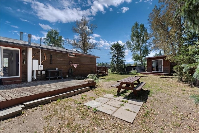 view of yard with an outdoor structure and a deck