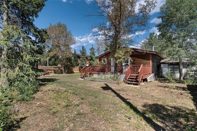 view of yard featuring a wooden deck and fence