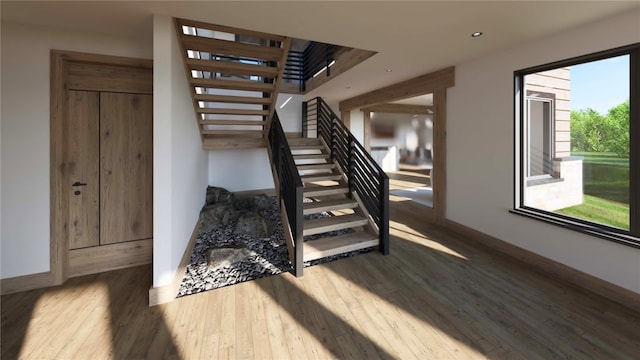 staircase with hardwood / wood-style floors