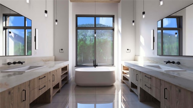 bathroom featuring tile patterned flooring, vanity, and a washtub