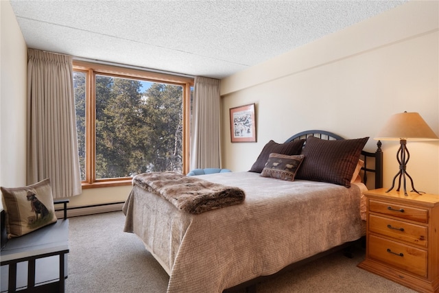 bedroom with carpet, a textured ceiling, and baseboard heating