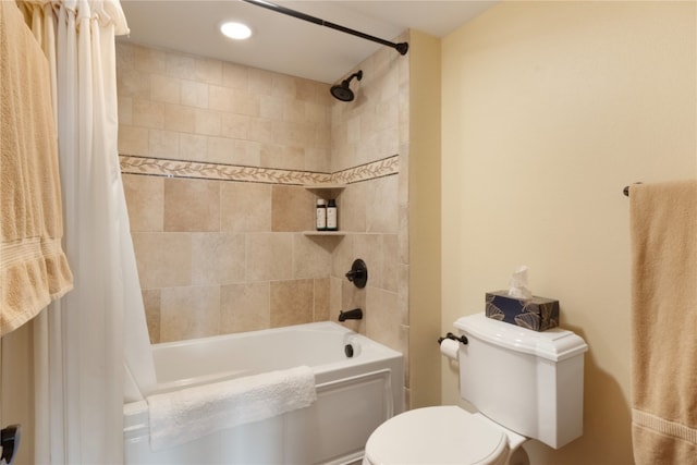 bathroom featuring shower / bath combo with shower curtain and toilet