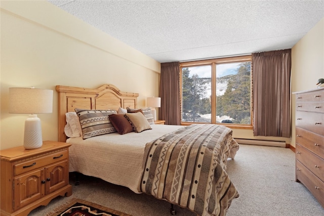 bedroom featuring baseboard heating, a textured ceiling, and carpet flooring